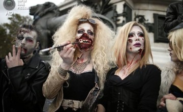 Four men dressed as zombies participate in a Zombie Walk procession in the streets of Paris