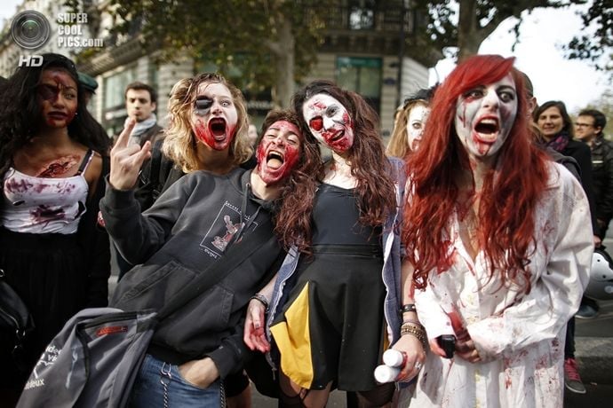 Women dressed as zombies participate in a Zombie Walk procession in the streets of Paris