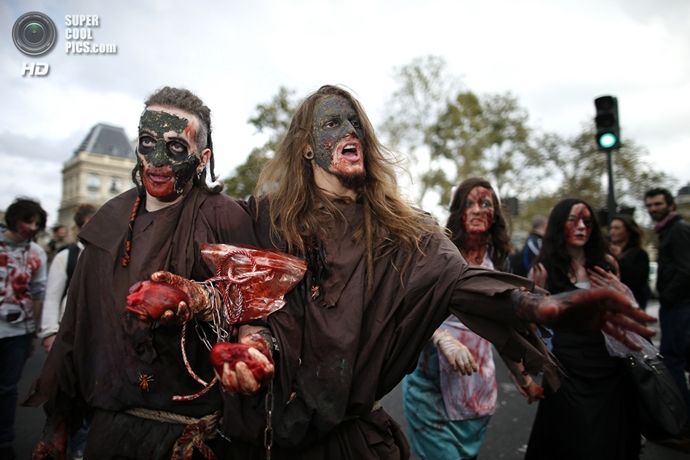 Two men dressed as zombies participate in a Zombie Walk procession in the streets of Paris