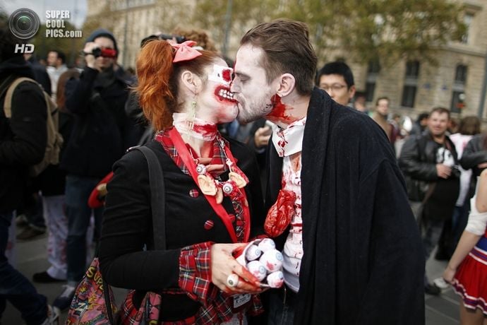 A couple dressed as zombies participates in a Zombie Walk procession in the streets of Paris