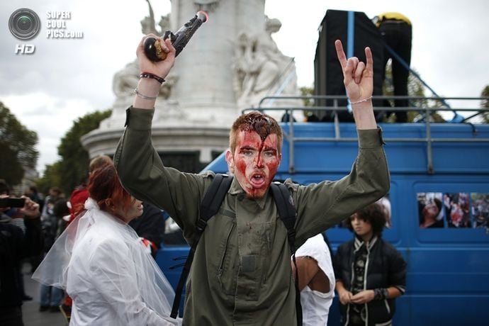 A man dressed as a zombie participates in a Zombie Walk procession in the streets of Paris