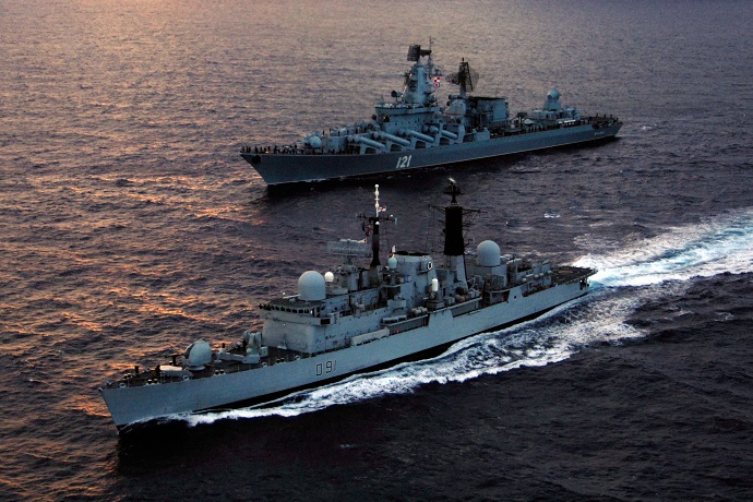 HMS Nottingham sails past the Russian cruiser RFS Moskva.